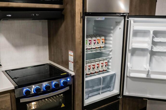 RV refrigerator with door open and soda inside