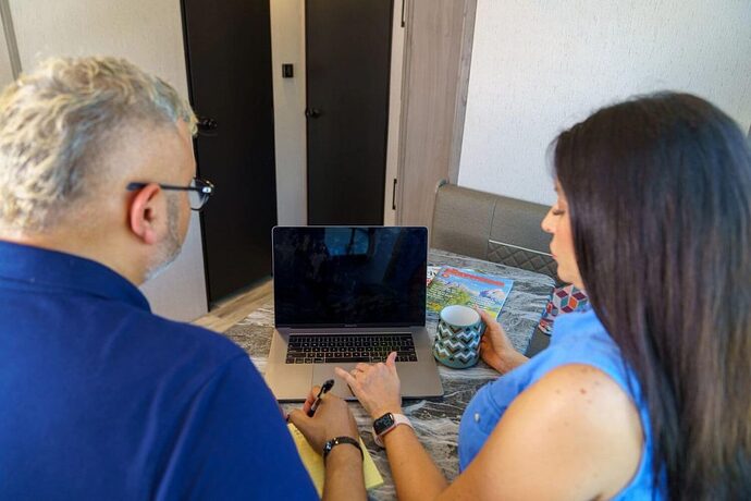 Couple researching RVs on their tablet computer
