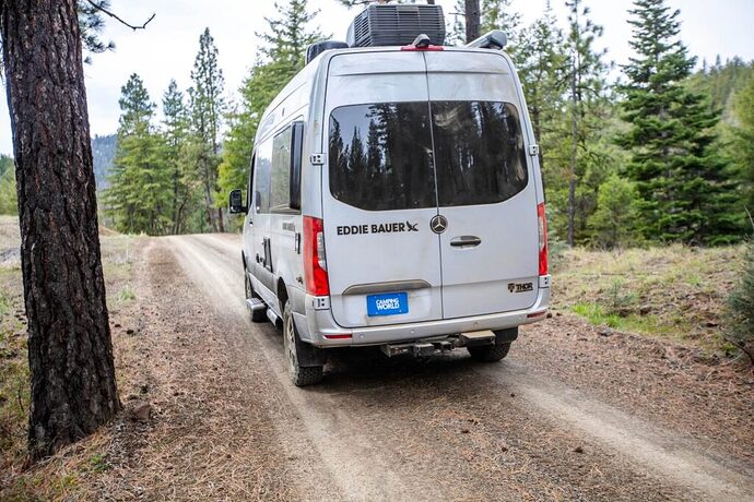 Thor Eddie Bauer Class B traveling through the woods