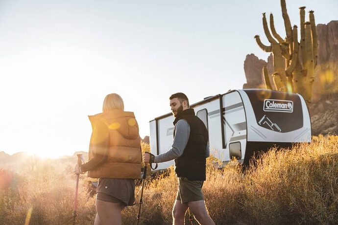 Couple in front of travel trailer