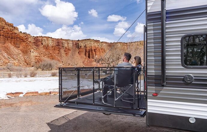 Couple sitting on toy hauler patio