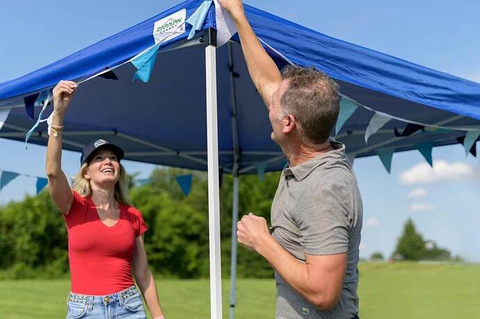 Couple setting up instant canopy shelter