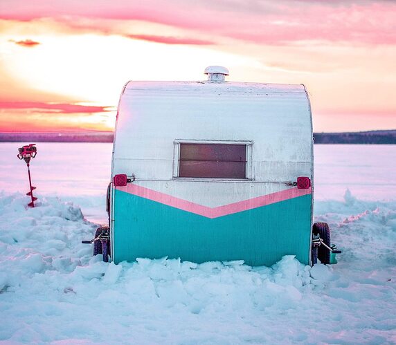 RV for ice fishing set up at dusk