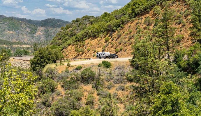 Jeep towing Jayco travel trailer in the mountains