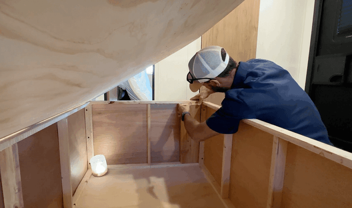 Installing wooden blocks to reinforce RV bed frame