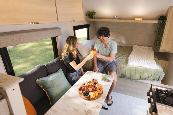 Couple sitting on RV sofa with replaced dinette cushions