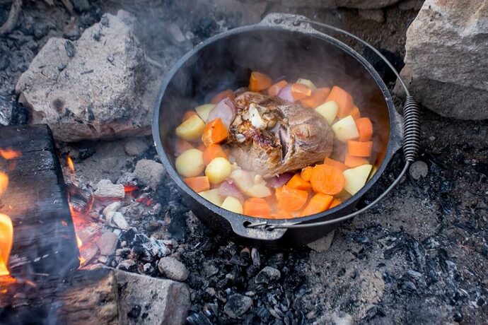Meat and veggies cooking in Dutch oven for RV cooking
