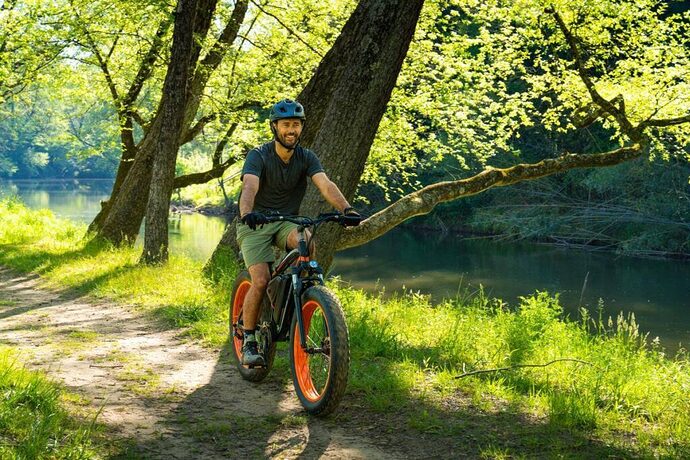 Man riding eBike on dirt trail