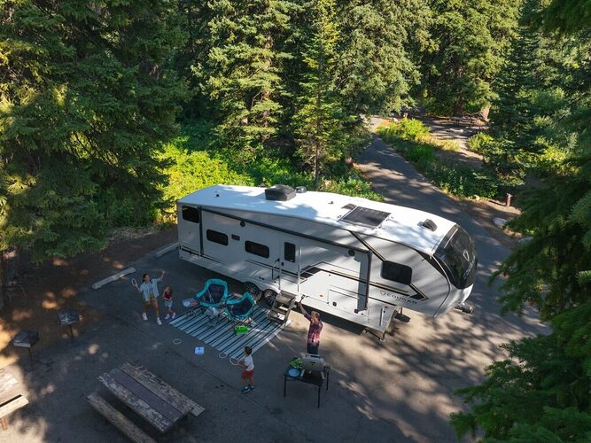 Fifth wheel RV parked at a campsite. 