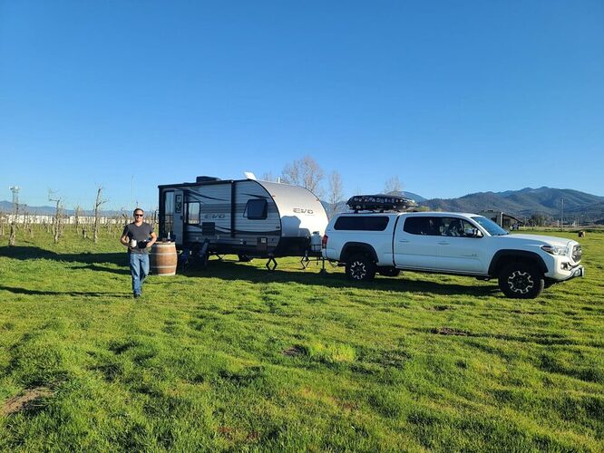Man delivering wine from toy hauler hooked up to Toyota Tacoma