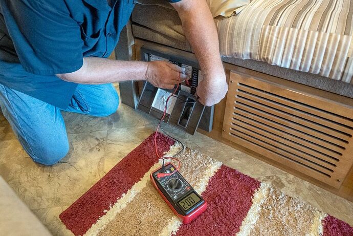 RV technician inspecting circuit breaker panel