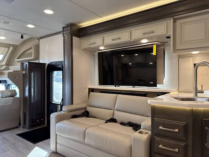Interior image of the Jayco Seneca Prestige 37M that shows the entrance and the the jackknife sofa. 