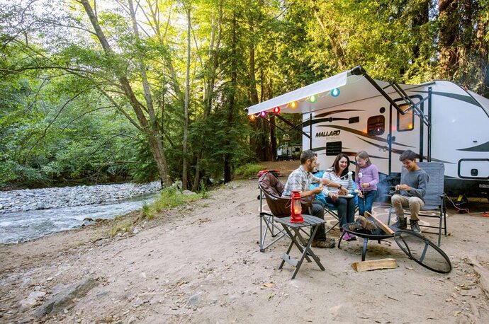 Family camping near home along a river