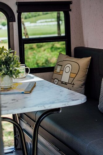 Decorative pillow on a dinette cushion in a small RV