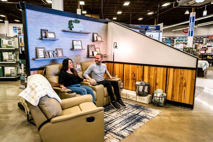 Couple testing RV theater seating in a Camping World Design Center