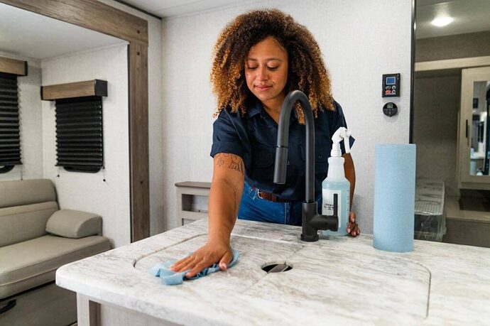 woman cleaning for summer rv prep