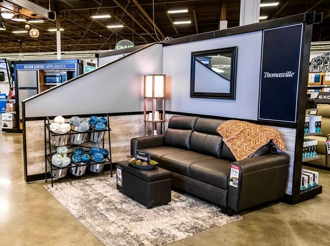 Sofa with storage ottoman in front of it in a Design Center at a Camping World location