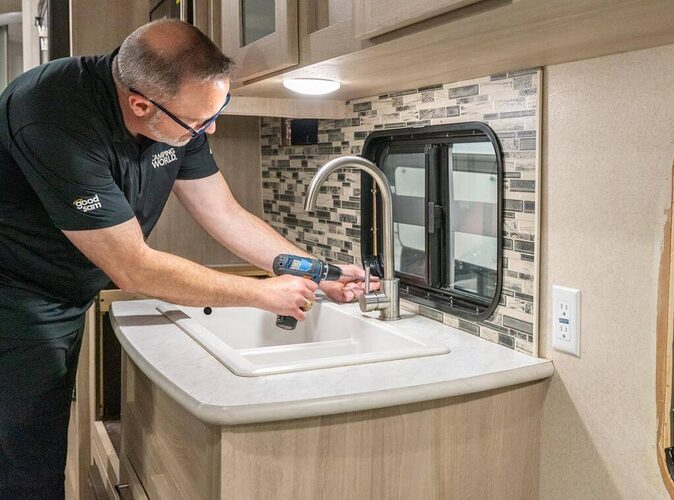 Technician fixing issue in RV kitchen