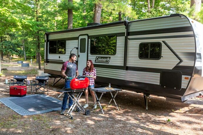 Couple outside travel trailer