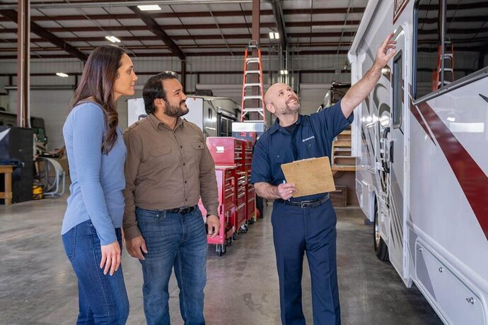 Technician completing RV inspection with owners to make a trade in offer