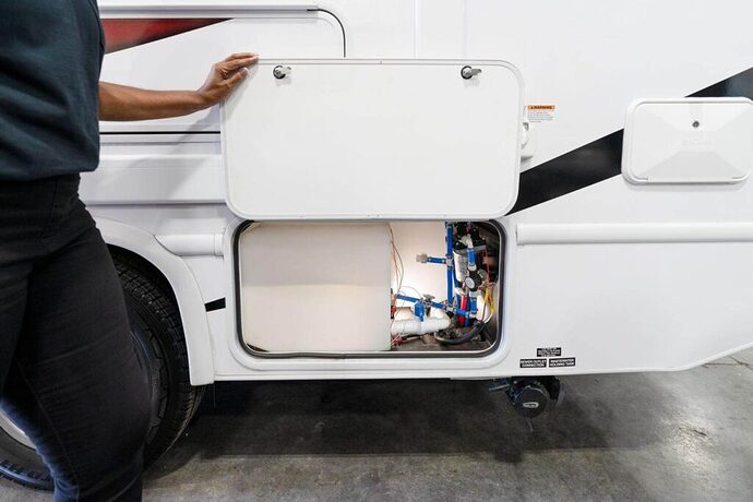Technician inspecting a camper's plumbing
