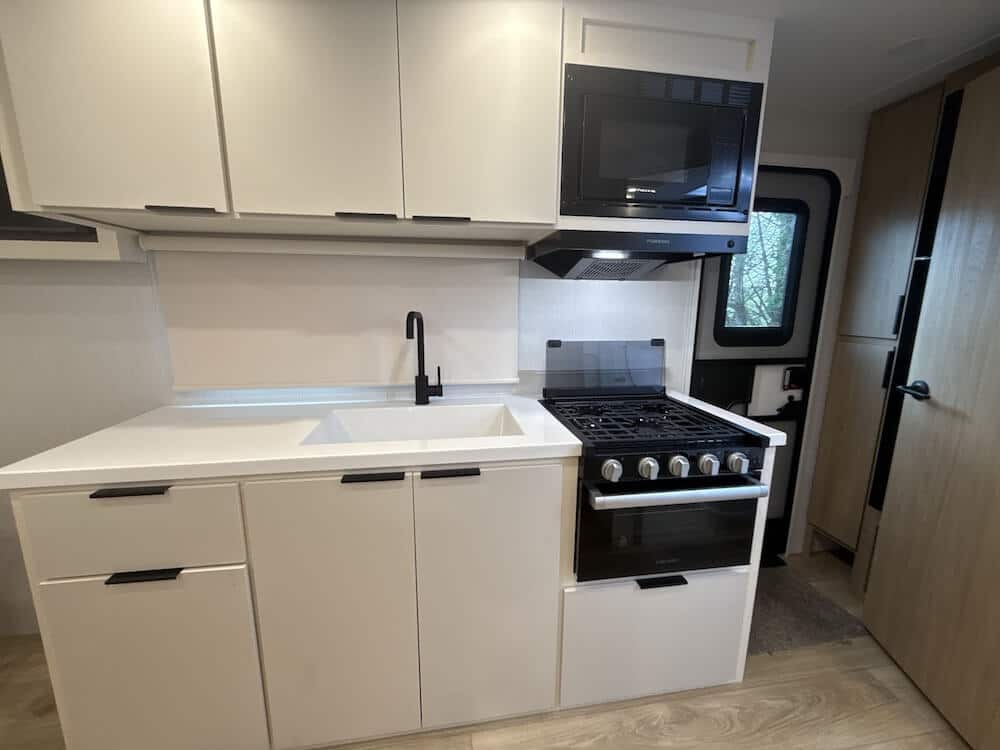 Image of the galley kitchen of the Winnebago Thrive 18FBS