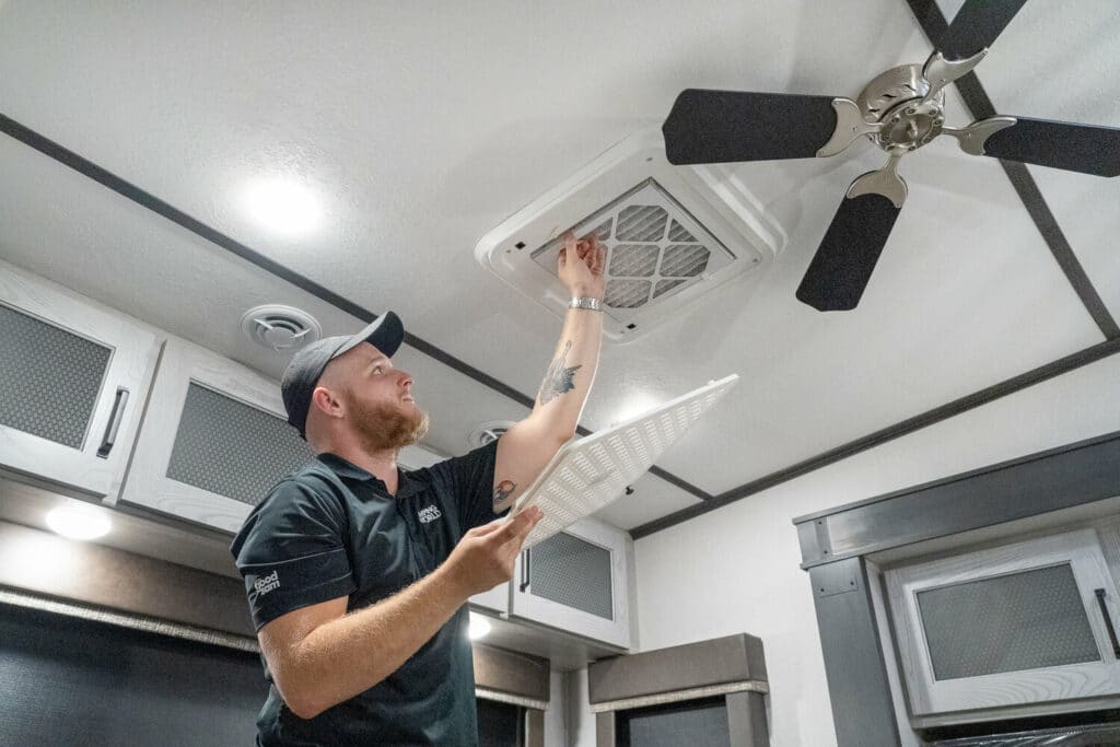 Technician inspecting RV AC air filter