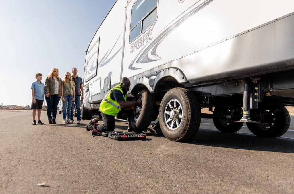 Technician changing tire after an RV breakdown